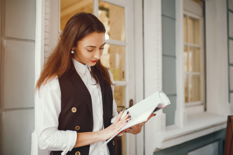 A curated stack of books and resources titled "The Ultimate Reading List for Hotel Revenue Managers," featuring essential reads on pricing strategy, demand forecasting, and hospitality analytics.